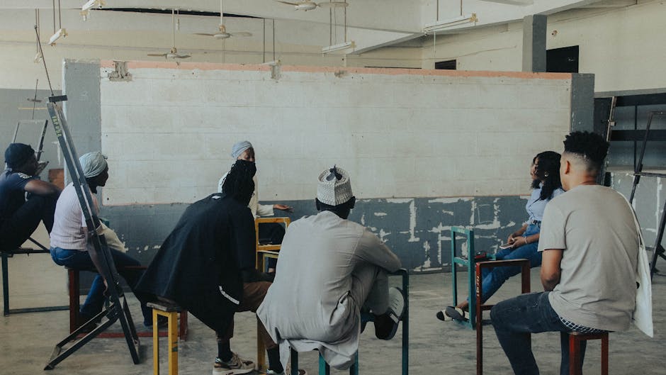 A group of diverse people sitting in a comfortable setting, engaged in a discussion.